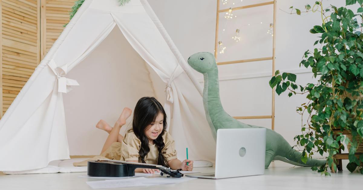 a-kid-drawing-near-a-laptop-3967107