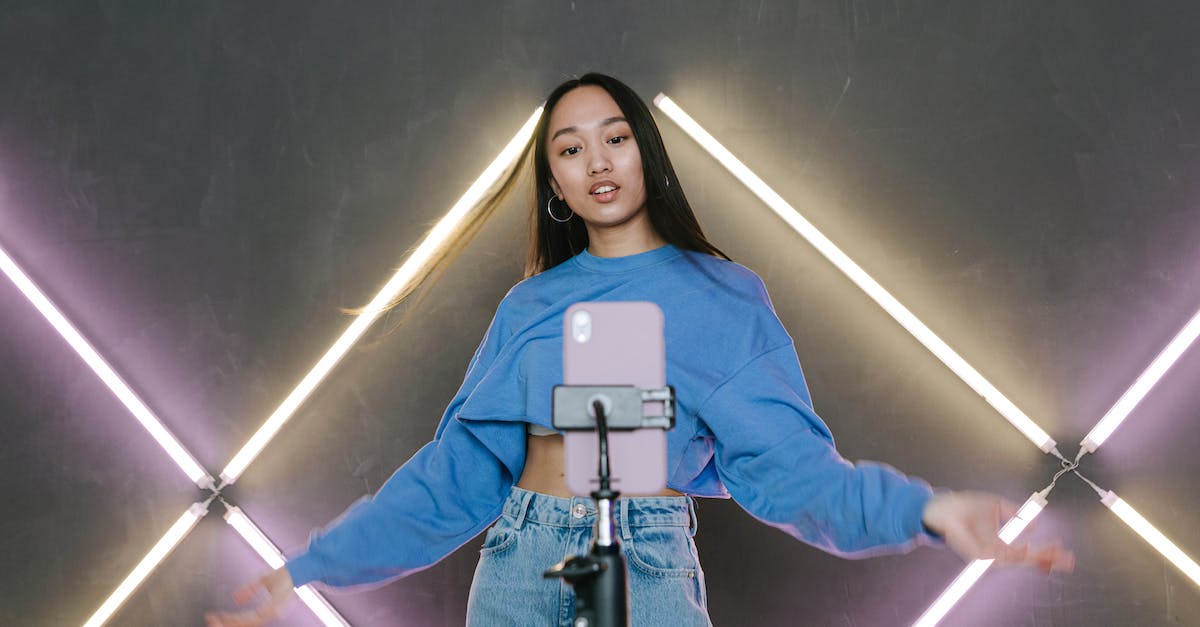 a-woman-in-blue-sweater-dancing-in-front-of-her-mobile-phone-on-a-tripod-8831830