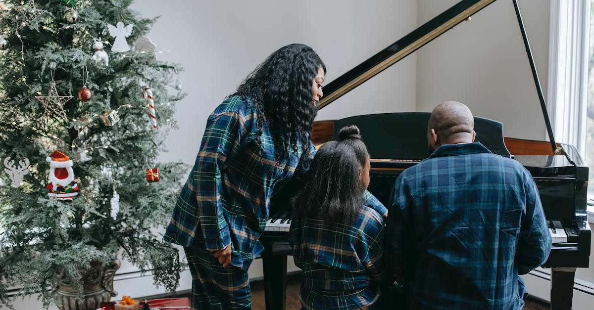 back-view-of-anonymous-african-american-family-playing-musical-instrument-in-cozy-room-with-decorate-5630021