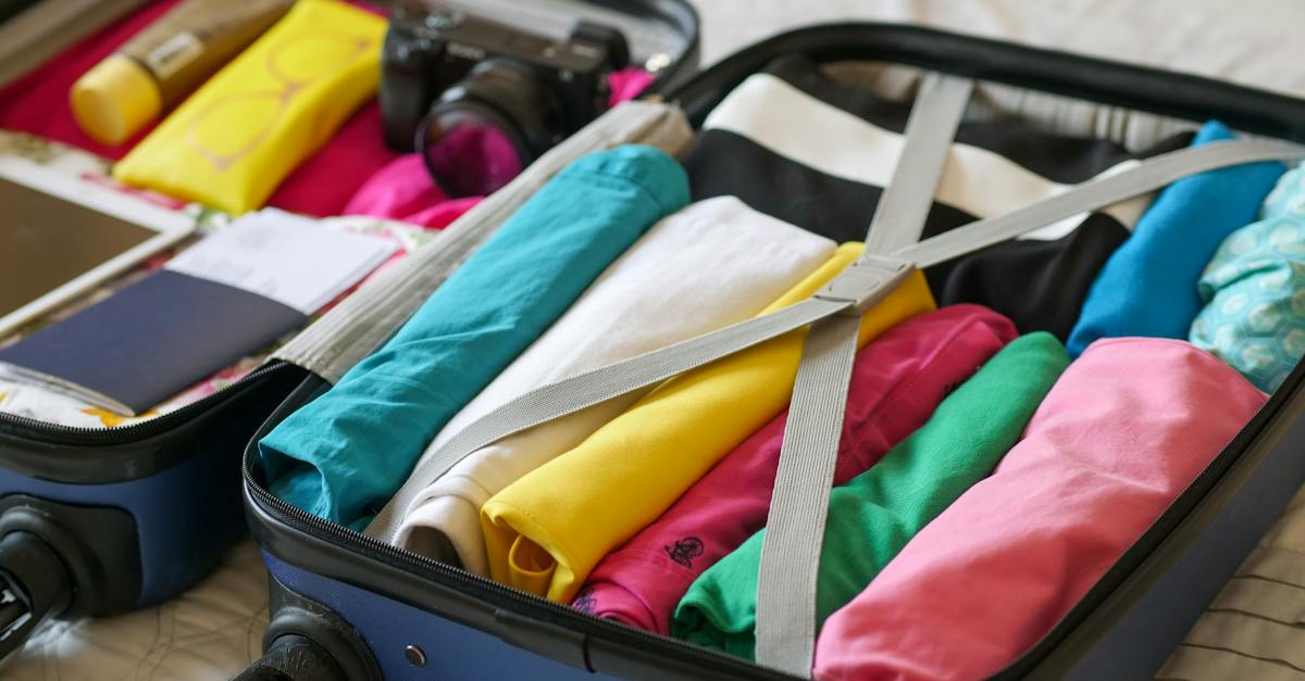 blue-luggage-with-folded-clothes-6759904