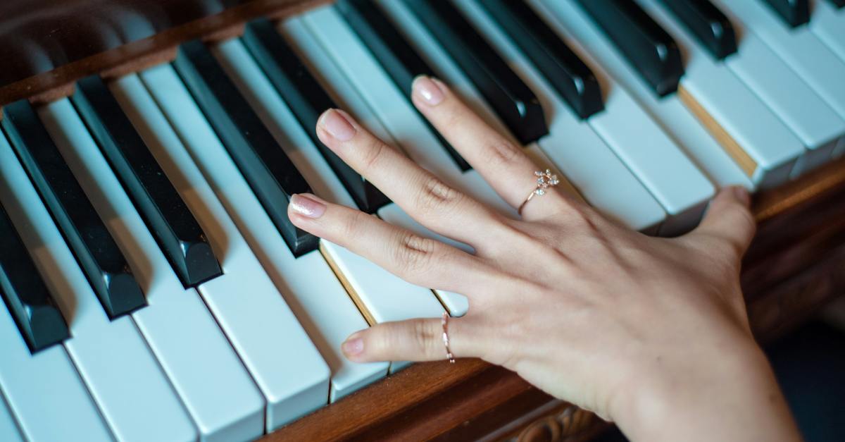 brown-wooden-piano-used-by-a-person-using-2-fingers-8950934
