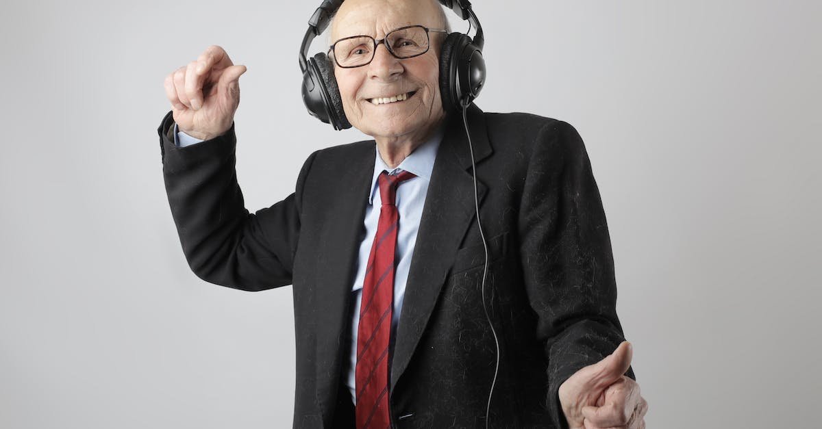 cheerful-elderly-man-listening-to-music-in-headphones-4876637