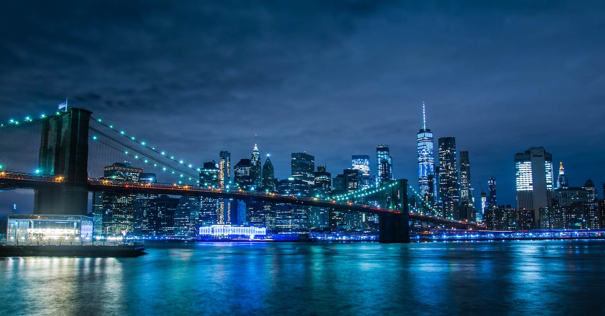 city-skyline-across-body-of-water-during-night-time-4431248