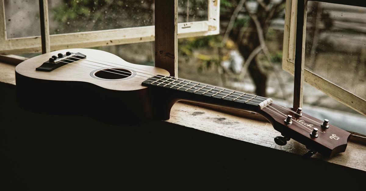 classic-acoustic-ukulele-placed-on-narrow-windowsill-of-old-rural-house-in-daylight-8043715