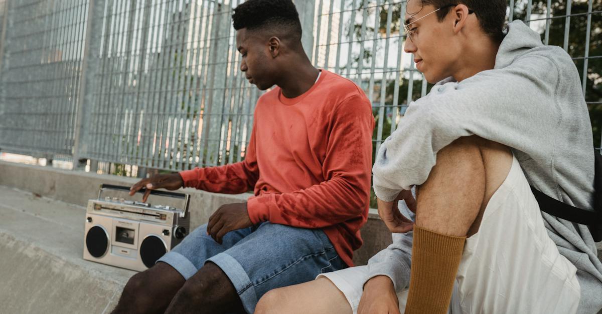 confident-youthful-multiracial-guys-listening-to-old-songs-on-retro-record-player-6245021
