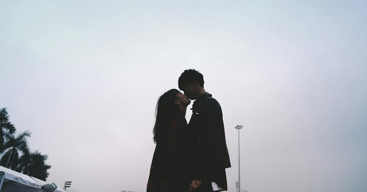 couple-kissing-together-standing-near-people-9328010