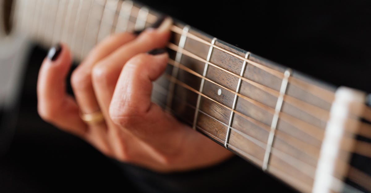 crop-faceless-woman-practicing-classical-guitar-technique-5874641