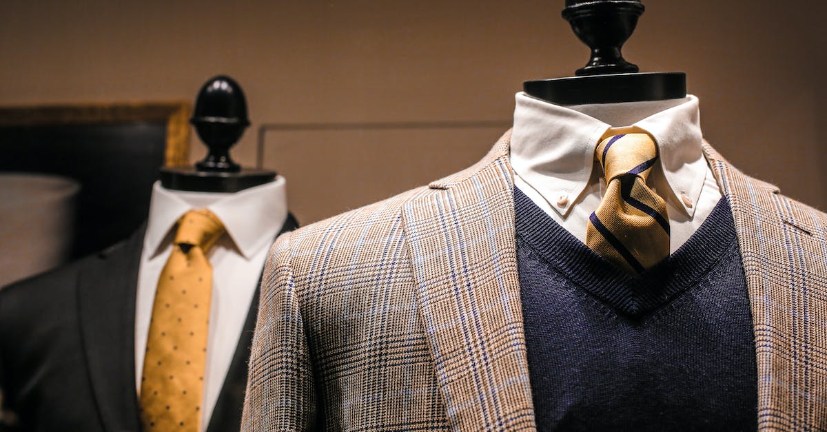 dandy-fancy-jackets-with-shiny-ties-on-dummies-in-showroom-of-contemporary-male-shop-9081134