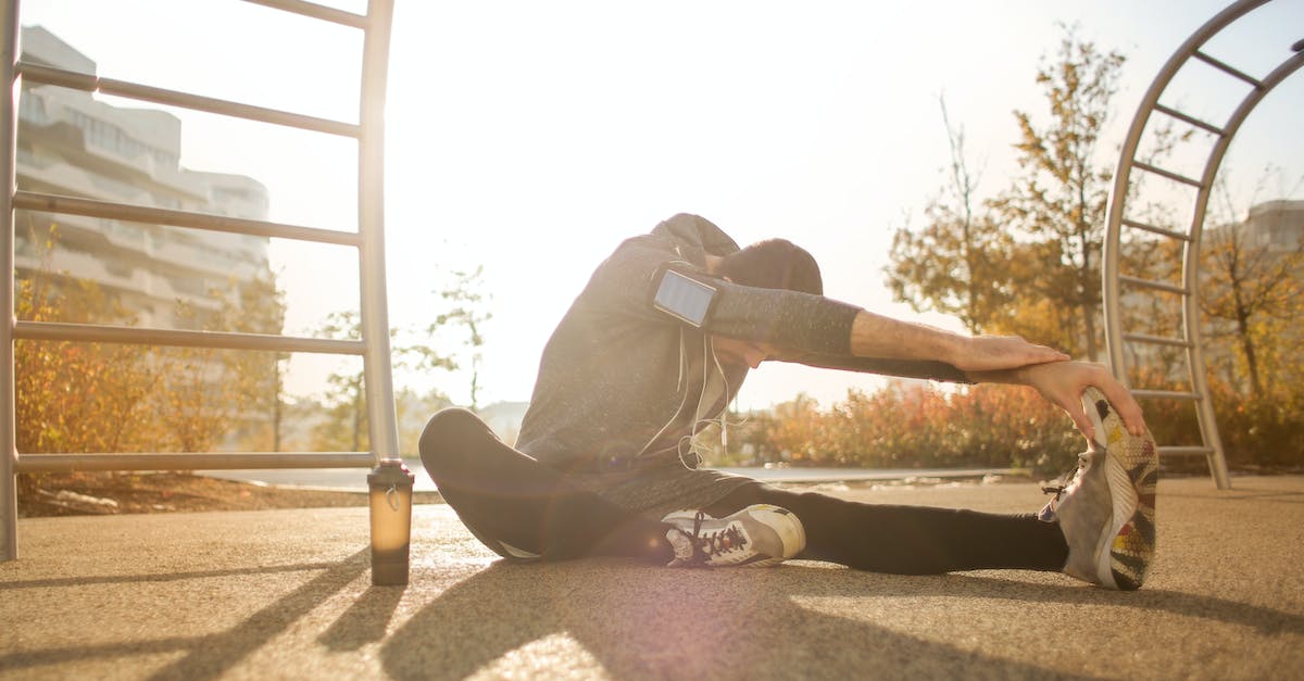 flexible-sportsman-stretching-on-sports-ground-5945854