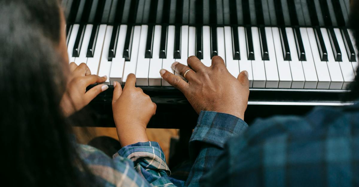 from-above-of-crop-anonymous-african-american-man-playing-musical-instrument-with-girl-while-rehears-8343099