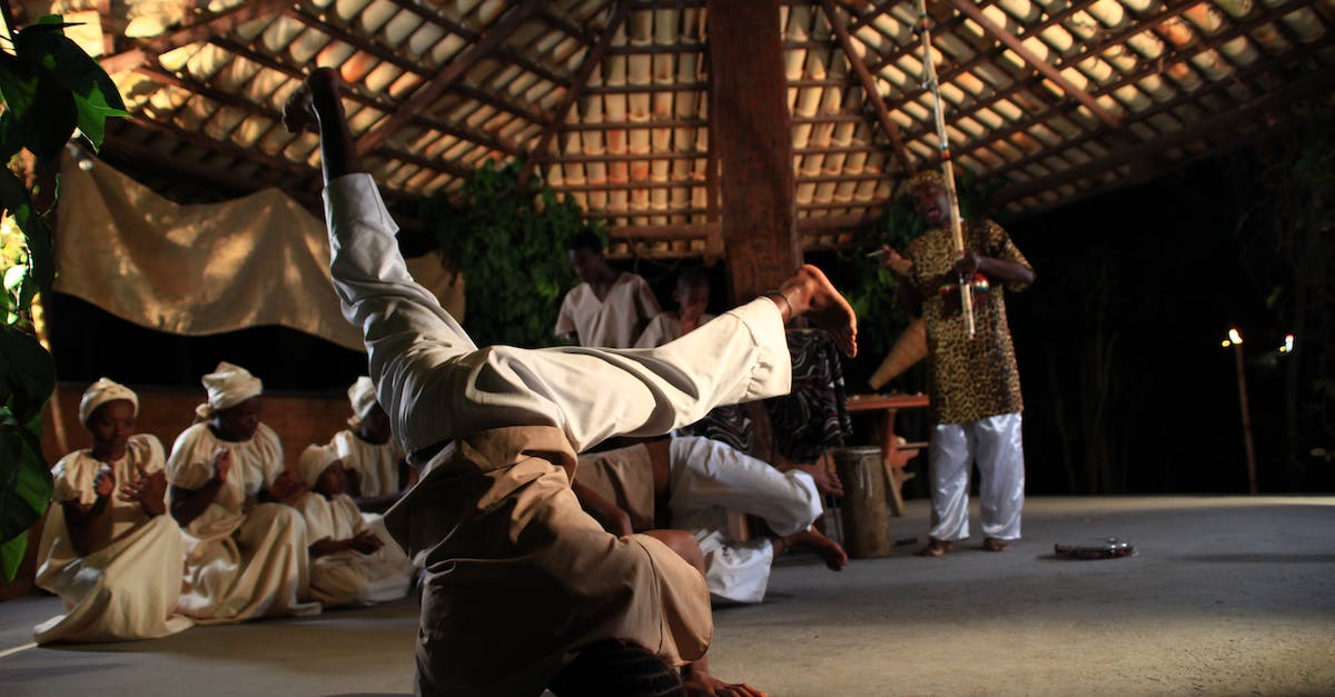 full-body-of-african-man-dancing-on-head-during-traditional-ceremony-in-village-2207335
