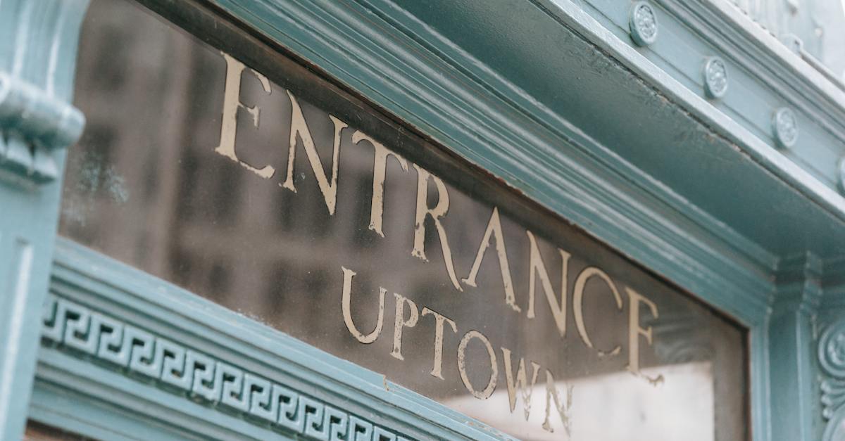 glass-signboard-with-inscription-placed-in-aged-fashioned-light-blue-facade-of-pub-on-street-in-dayl-5171754