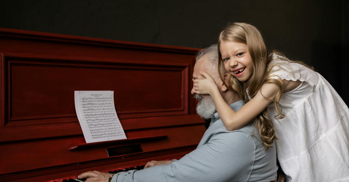 granddaughter-covering-her-grandfather-s-eyes-while-playing-the-piano-3548054
