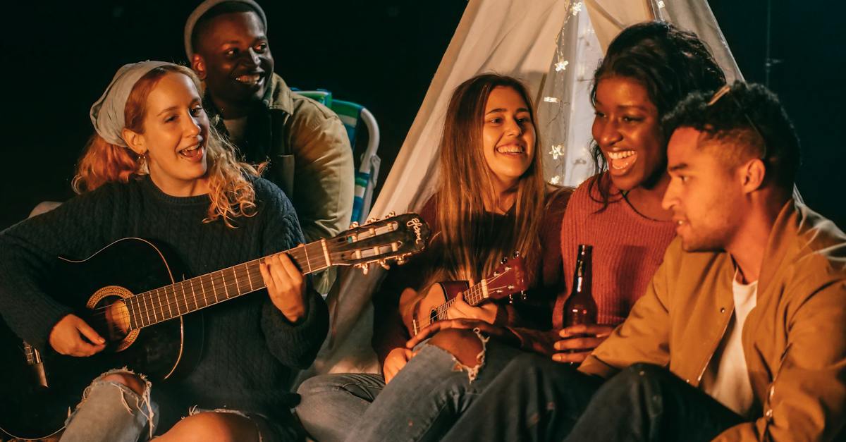 group-of-friends-singing-while-sitting-on-beach-shore-1865565