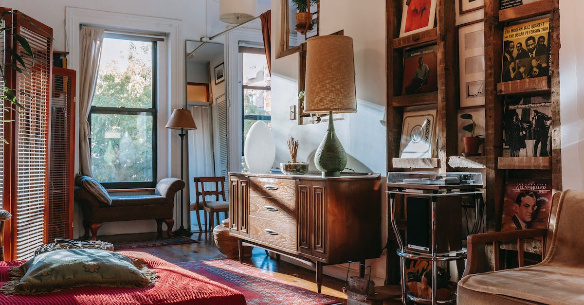 interior-of-cozy-studio-with-bed-and-couch-decorated-with-vintage-furniture-and-vinyl-records-8208048