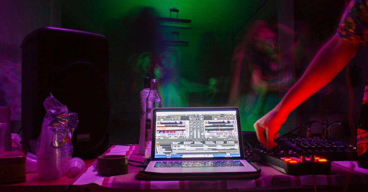 long-exposure-photo-of-person-using-laptop-and-audio-mixer-7630481