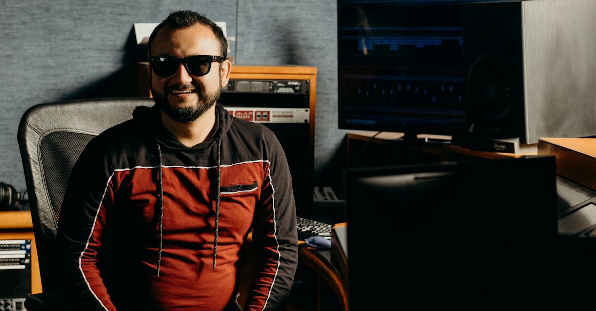 man-in-black-and-red-long-sleeve-shirt-wearing-black-sunglasses-inside-the-music-studio-6981723