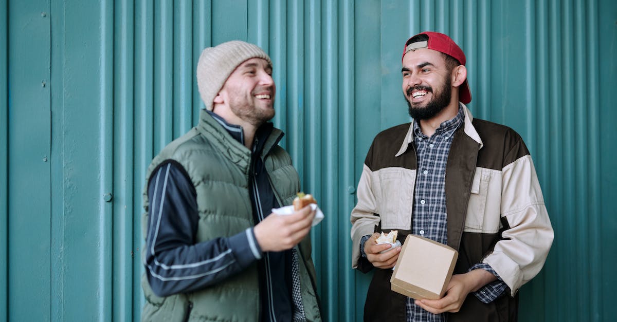 man-in-green-jacket-holding-white-box-1020408