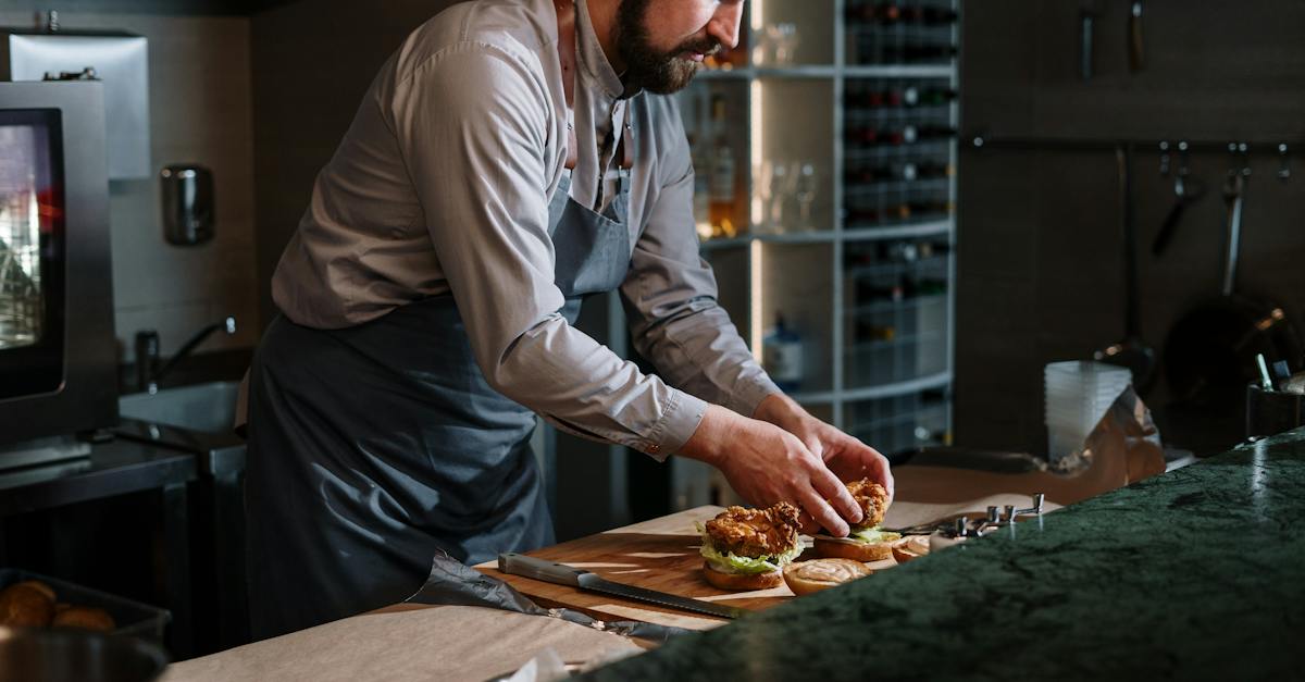man-in-white-dress-shirt-slicing-pizza-1007248