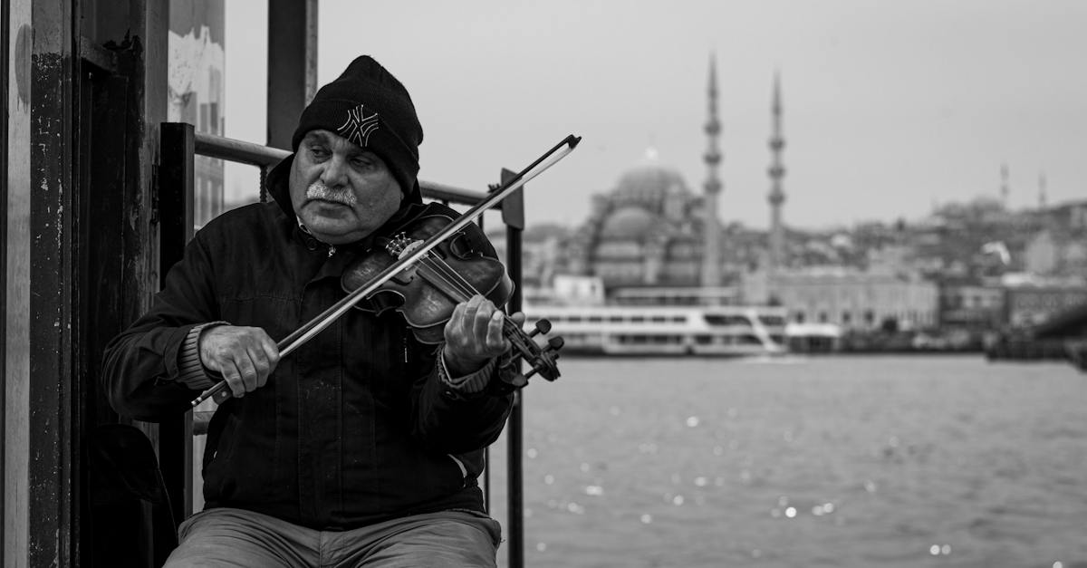 man-playing-the-violin-on-the-street-with-the-view-of-the-bosphorus-strait-and-a-mosque-behind-him-4951143