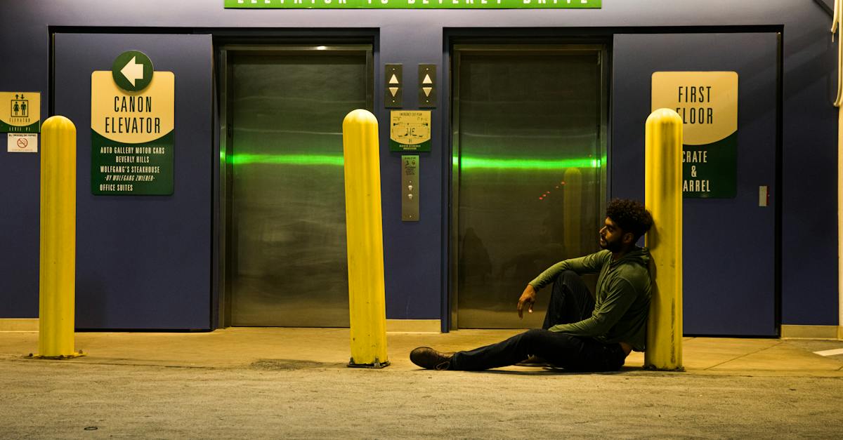 man-sitting-on-ground-near-an-elevator-lobby-4159764