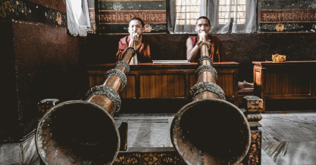 man-tibetan-musicians-playing-dungchen-instrument-in-temple-9126352