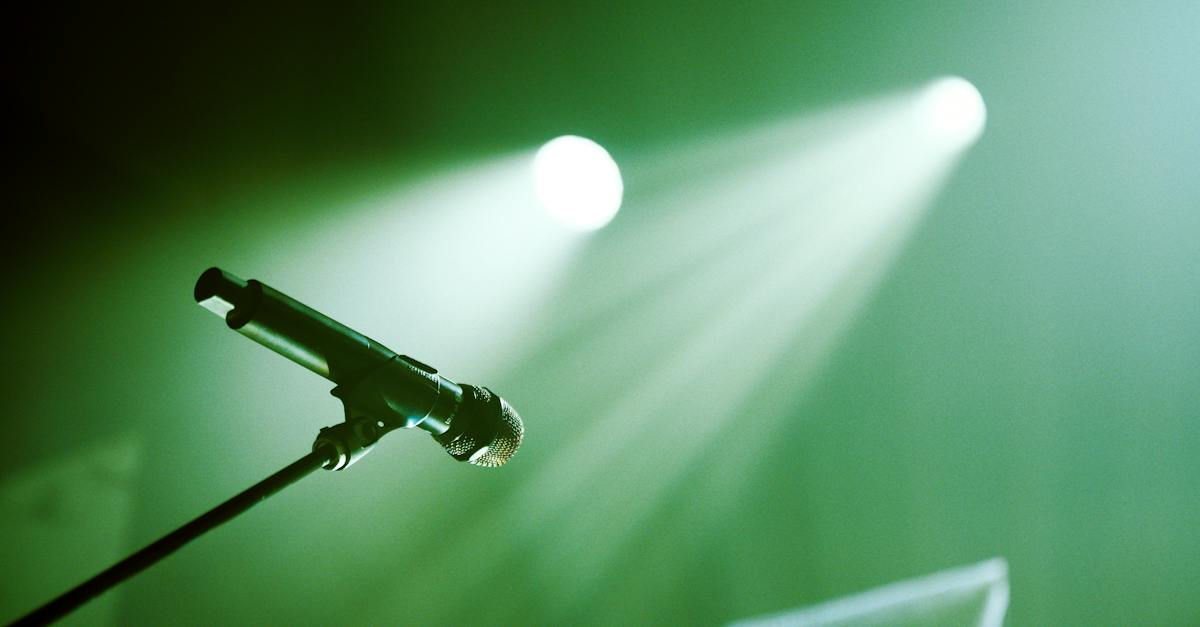 microphone-on-stand-placed-on-stage-with-green-lights-2592019