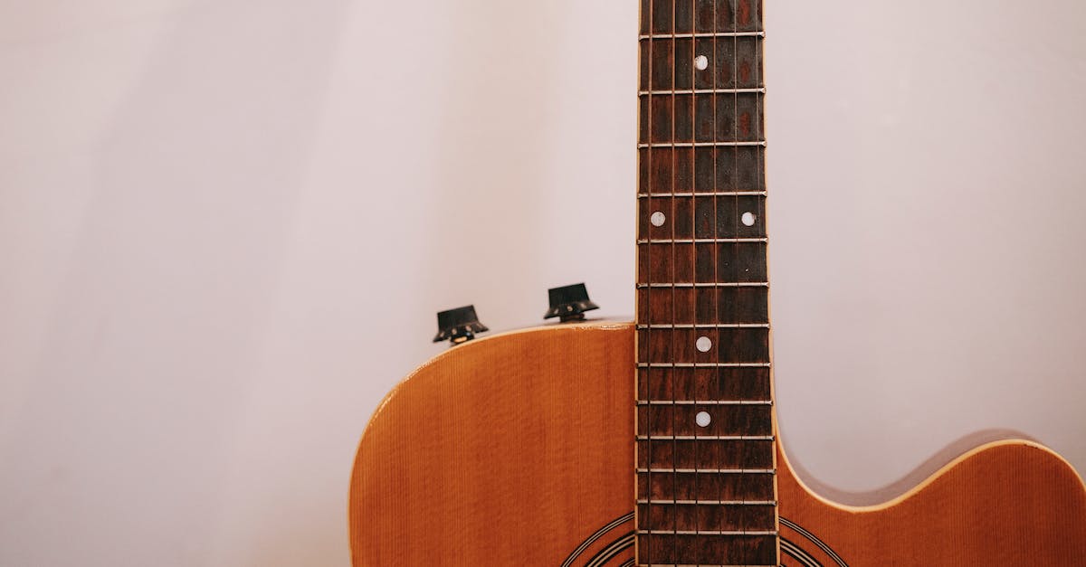 neck-of-acoustic-guitar-on-white-background-6441926