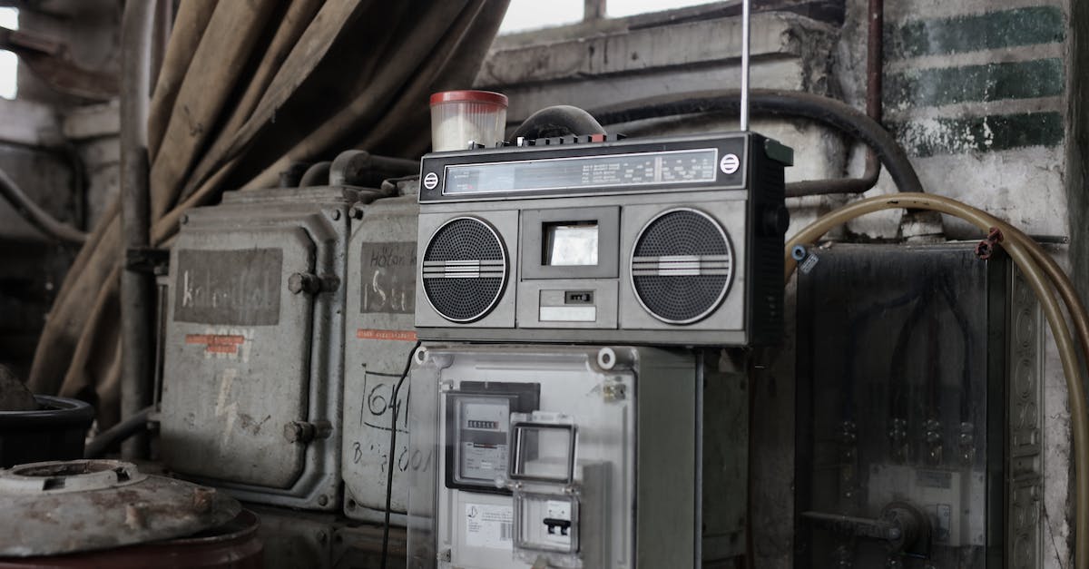 old-fashioned-cassette-player-placed-in-shabby-garage-near-old-industrial-equipment-3684776