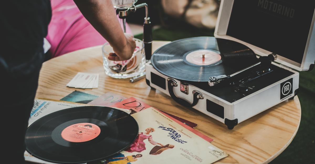 person-near-vinyl-record-player-on-brown-surface-4476083