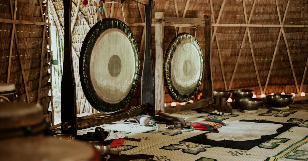 person-playing-drum-set-near-brown-wooden-wall-6285673