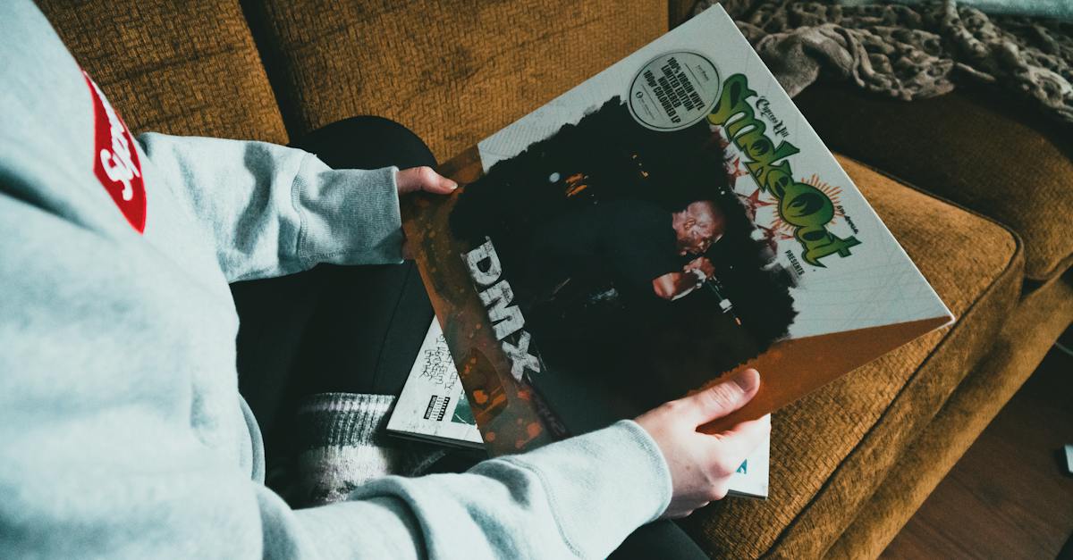 person-sitting-on-sofa-and-showing-vinyl-record-in-cover-6162777