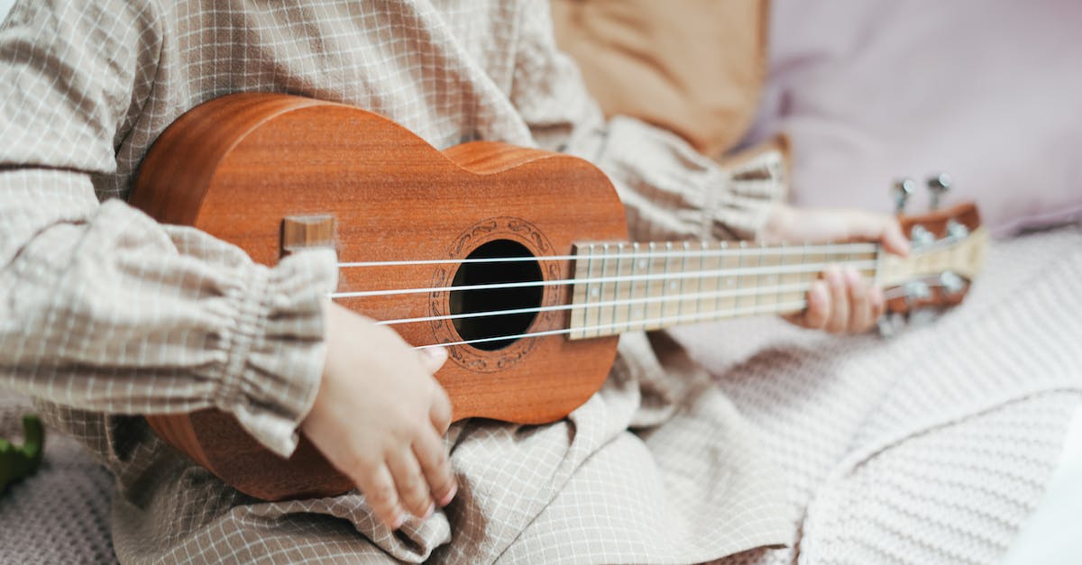 photo-of-a-toddler-playing-a-ukulele-2451350