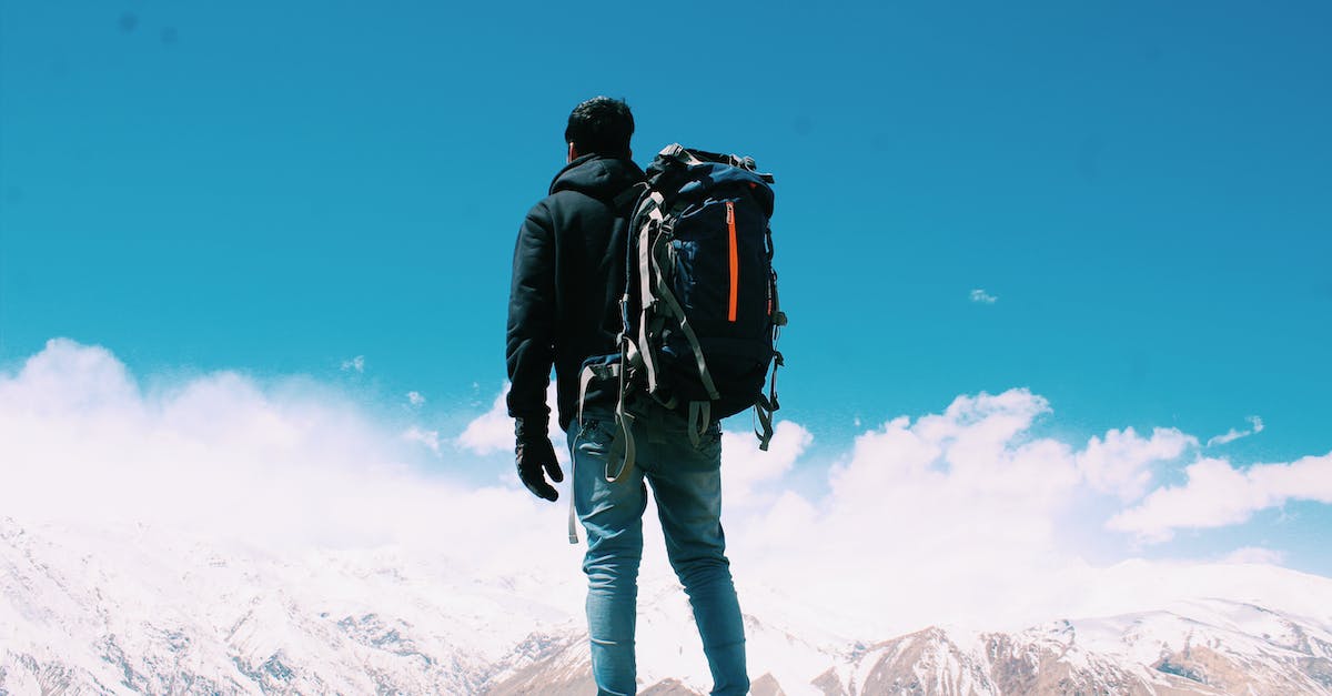 photo-of-man-standing-on-top-of-mountain-2752105
