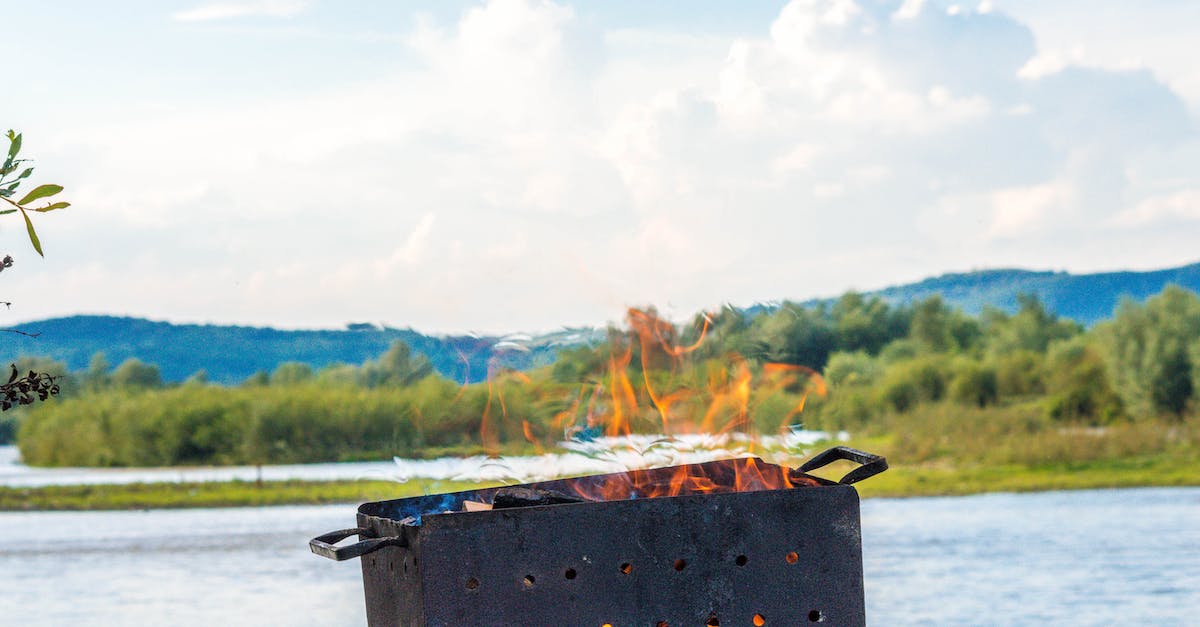 rectangular-black-metal-lighted-fire-pit-near-river-6170391