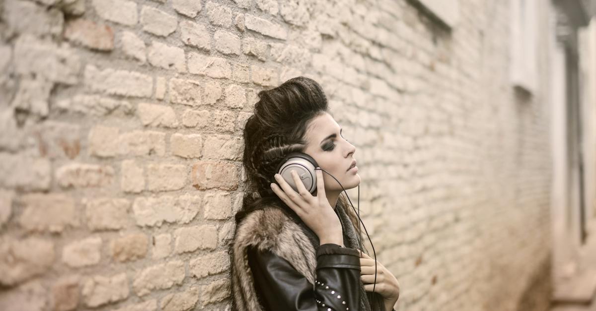 side-view-of-informal-female-in-leather-jacket-and-fur-vest-standing-on-street-with-closed-eyes-and-9573927