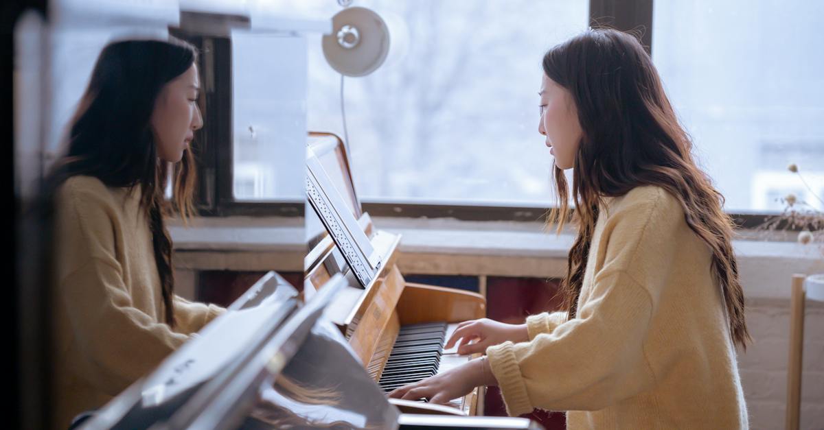 side-view-of-young-ethnic-female-pianist-playing-piano-while-watching-music-score-during-rehearsal-1727968