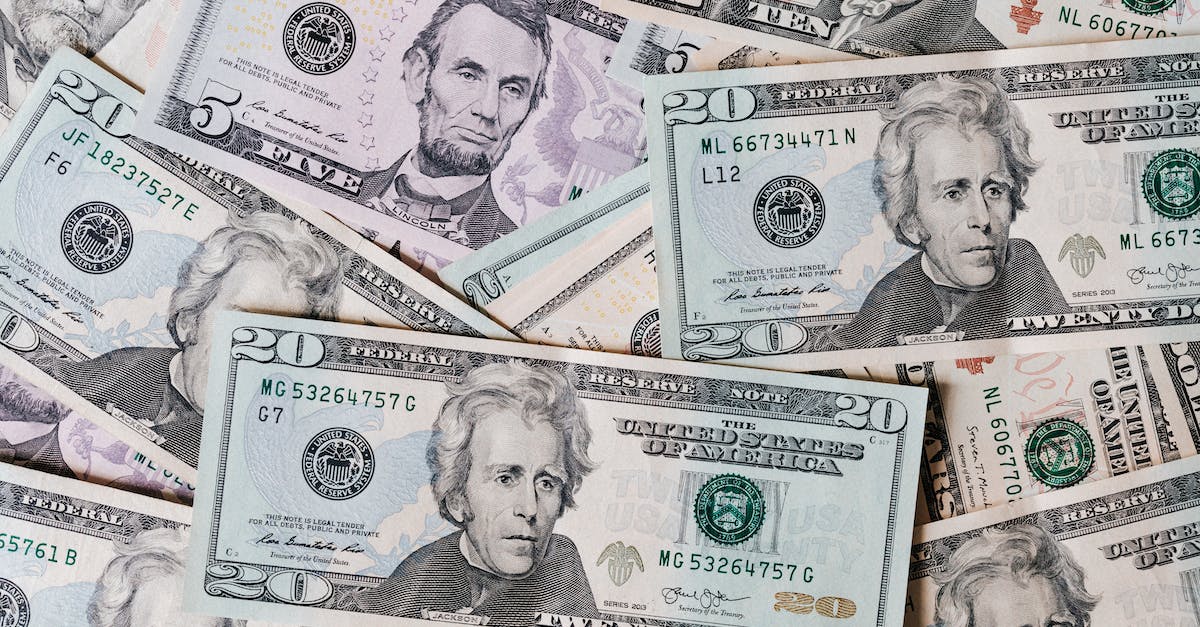 top-view-of-different-types-and-colors-american-dollars-placed-together-on-each-other-3383073