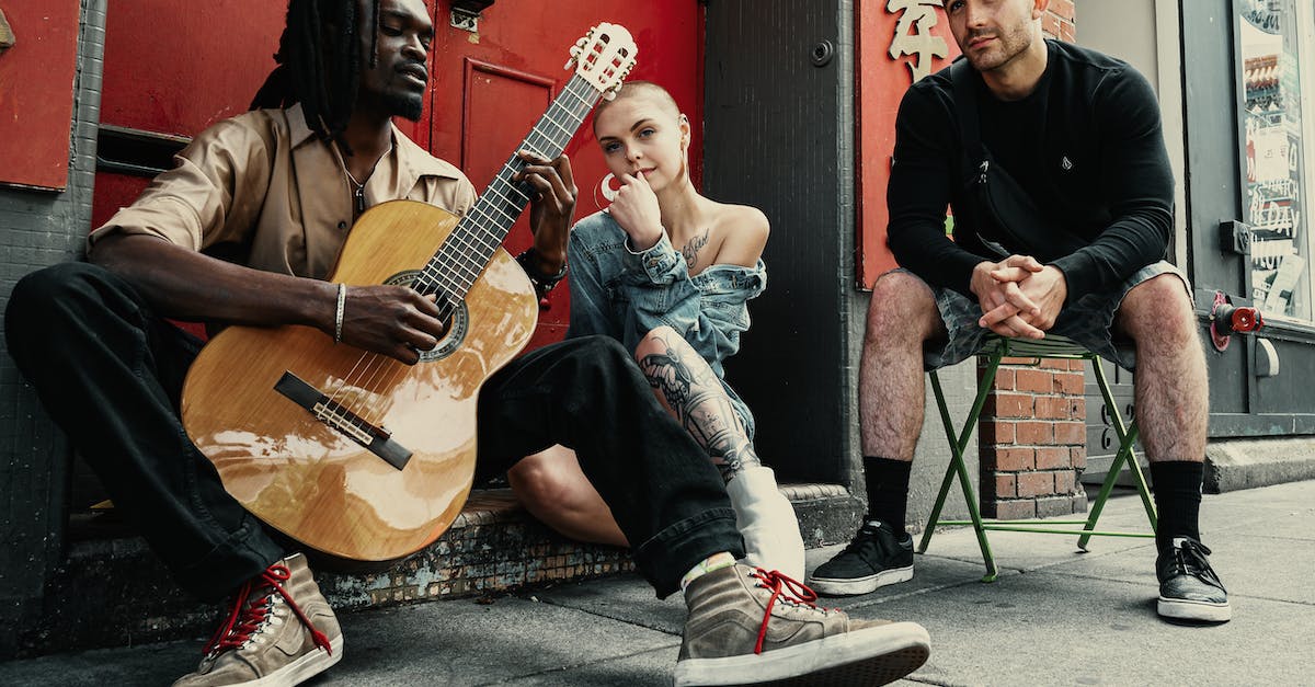 two-men-and-woman-sitting-next-to-each-other-2995228