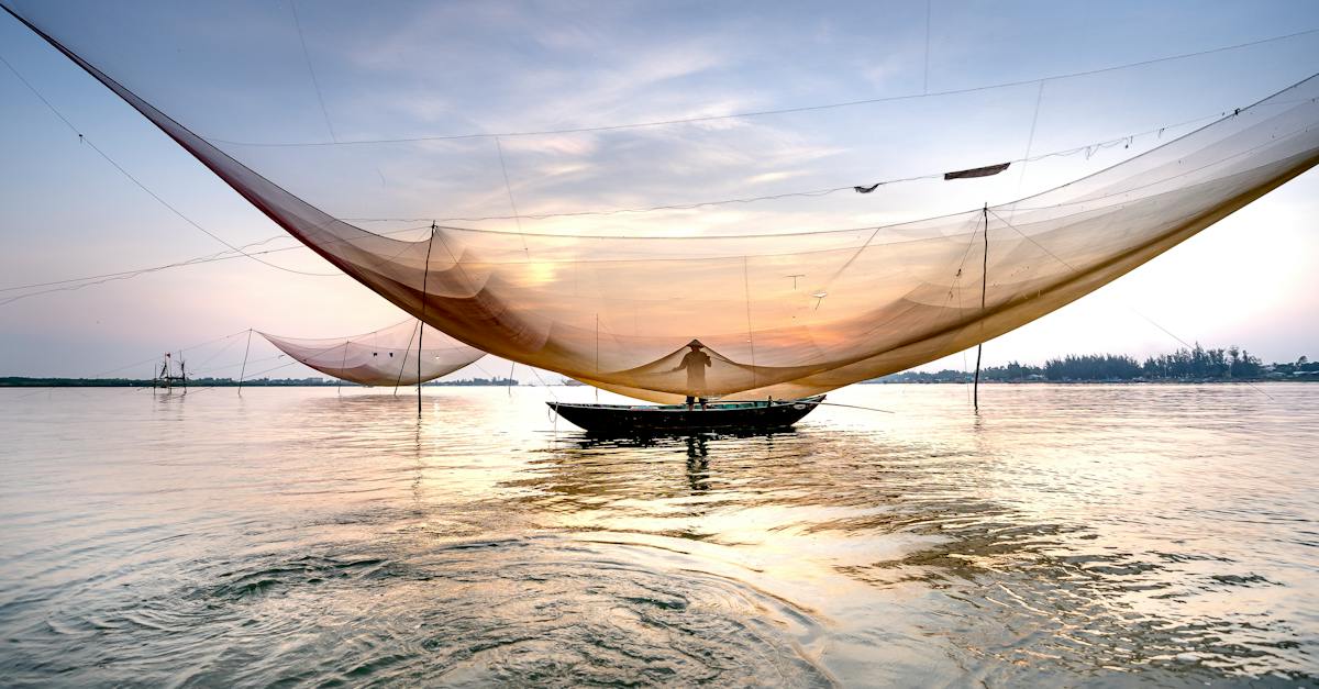 unrecognizable-man-near-fishing-net-on-sea-8786220