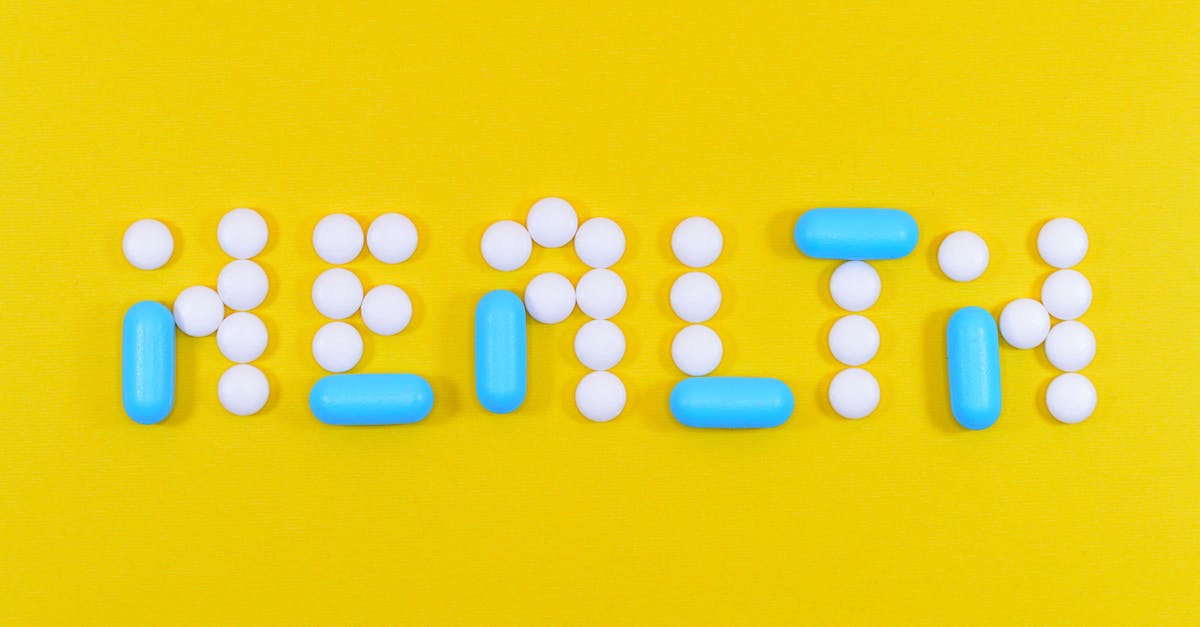 white-and-blue-health-pill-and-tablet-letter-cutout-on-yellow-surface-7373827