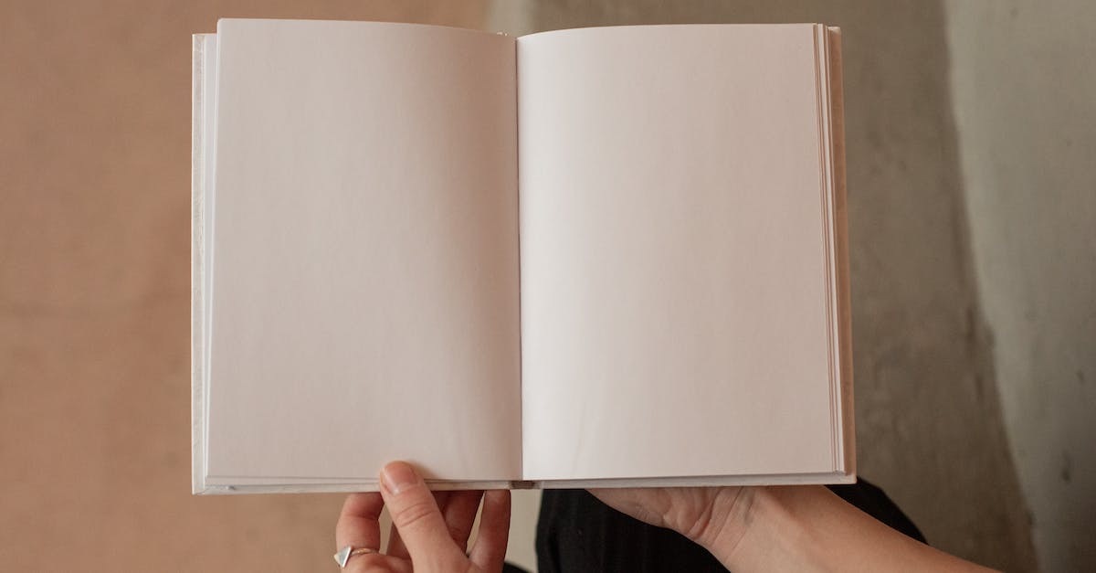 woman-holding-book-with-blank-pages-8983499