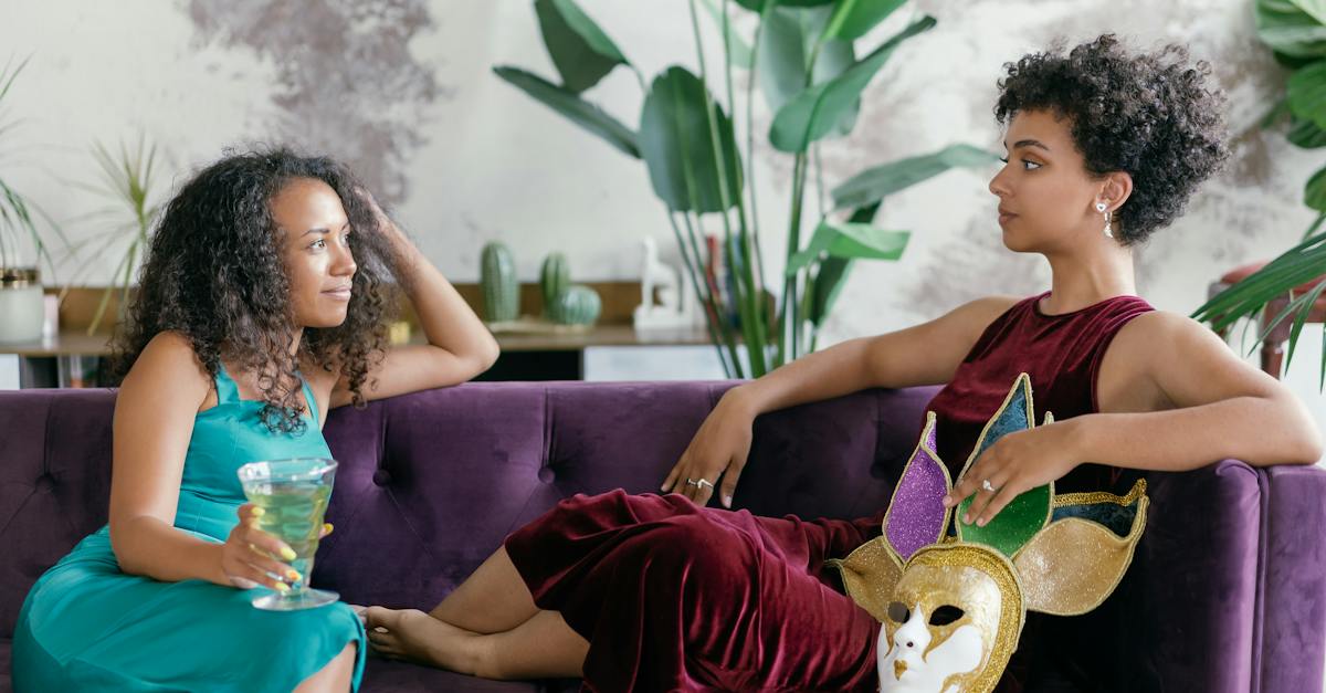 woman-in-blue-and-white-floral-dress-sitting-on-purple-couch-2479729