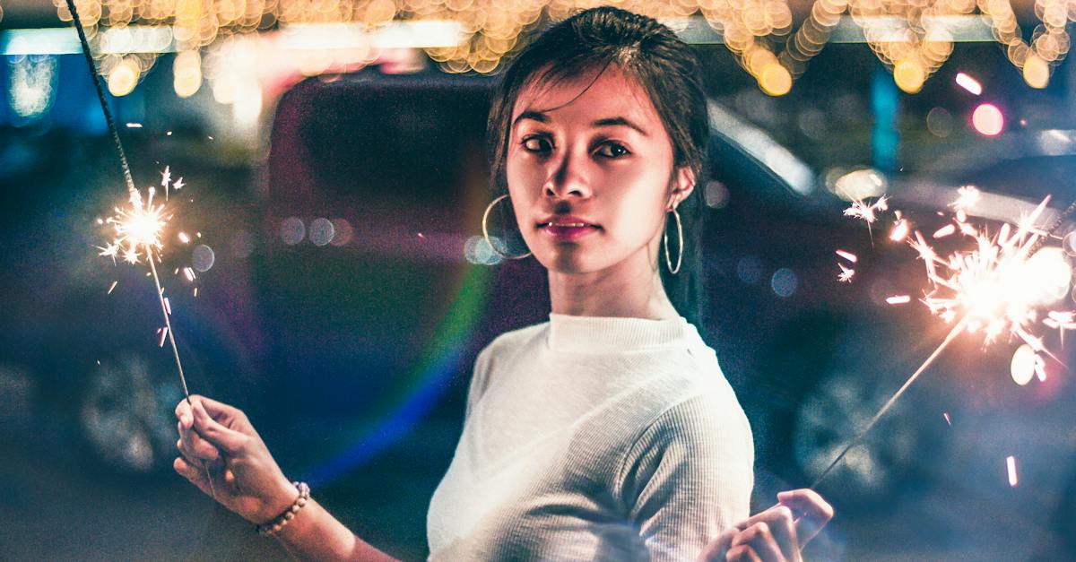 woman-in-white-crew-neck-shirt-standing-in-front-of-lighted-city-buildings-during-night-time-2738232