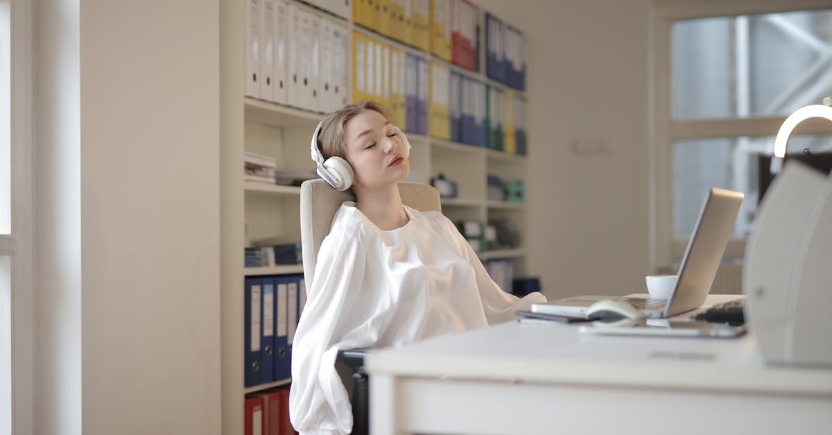 woman-in-white-dress-shirt-sitting-on-chair-4306073