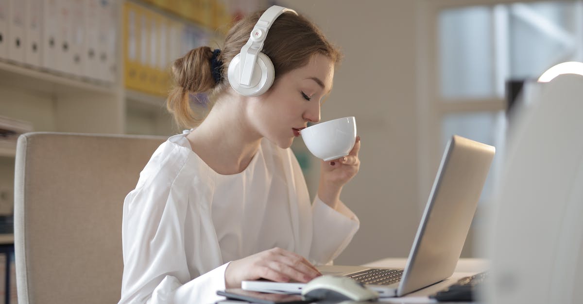 woman-in-white-dress-shirt-using-white-laptop-computer-3022825