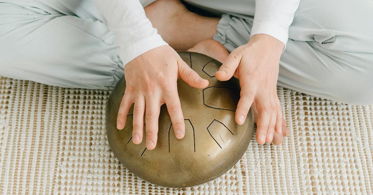 woman-sitting-on-floor-with-hapi-drum-9513282