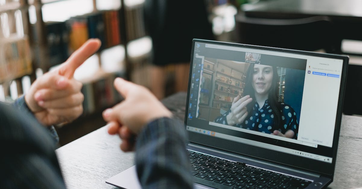 young-lady-learning-sign-language-during-online-lesson-with-female-tutor-4371040